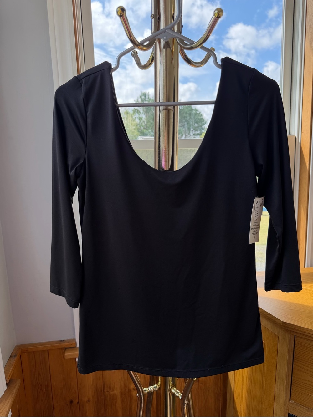 NWT H&M black long lycra sleeve top with a scoop neckline. Size M